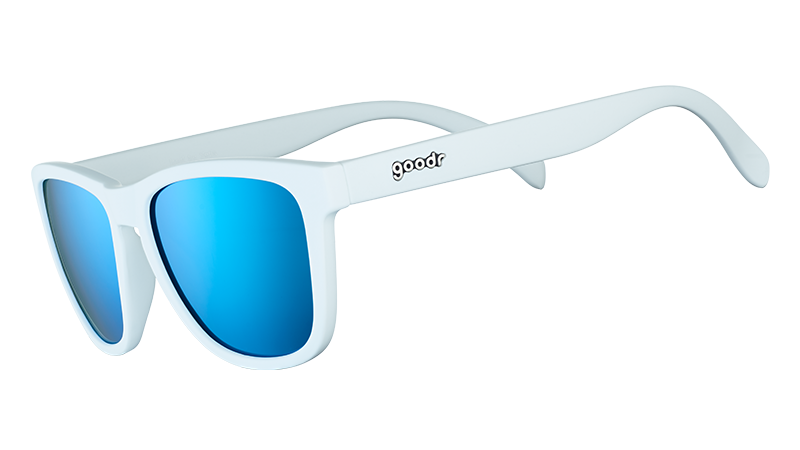 Three-quarter angle view of square-framed white sunglasses with blue reflective polarised lenses.