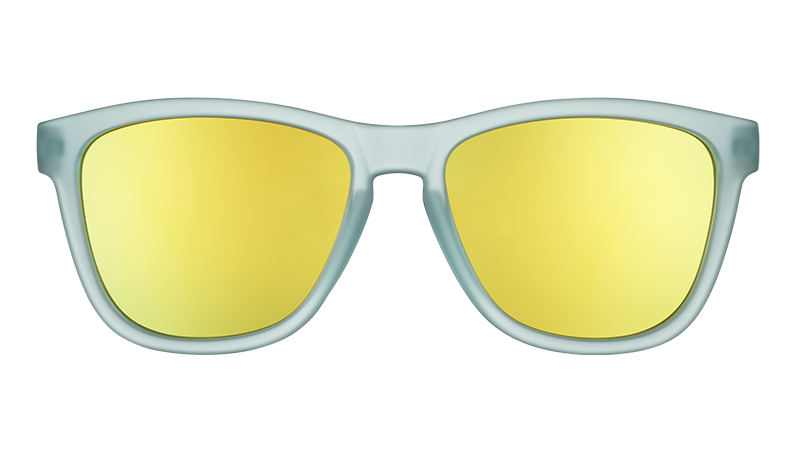 Front view of sunglasses with light blue translucent frames and reflective gold lenses.